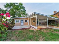 Charming single-story home with a covered carport and meticulously landscaped front yard featuring vibrant flowering shrubs at 224 Georgia Ave, Crystal Beach, FL 34681