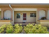 Inviting covered front entrance with decorative lattice and well-maintained landscaping, plus updated exterior paint at 2460 Northside Dr # 802, Clearwater, FL 33761
