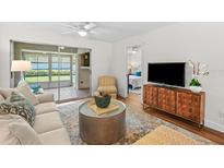 Comfortable living room with a sliding glass door to a patio and a glimpse of the bedroom at 2460 Northside Dr # 802, Clearwater, FL 33761