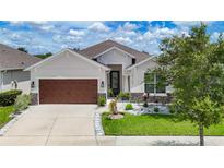 Charming single-Gathering home showcasing well-manicured lawn and inviting two-car garage at 34163 Radley Way, Wesley Chapel, FL 33545