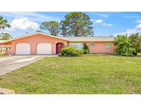 Charming single-story home with a well-maintained lawn and a two-car garage at 358 Suwanee Ave, Sarasota, FL 34243
