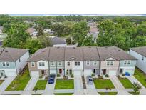 New townhomes showcase modern architecture, manicured lawns, and private driveways in a vibrant community at 4338 Banjo Lake Rd, Land O Lakes, FL 34639