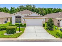 Charming single-story home with a manicured lawn, tasteful landscaping, and a two-car garage at 9751 Conservation Dr, New Port Richey, FL 34655
