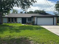 Charming single-story home with well-maintained lawn and attached two-car garage on a sunny day at 9903 Saddle Rd, Tampa, FL 33626