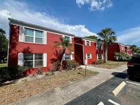 Charming two-story condo building with brick facade, white shutters, and well-maintained landscaping at 1025 82Nd N Ter # 1025D, St Petersburg, FL 33702