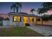 Charming home featuring a carport, a brick driveway, and lush landscaping, offering both style and functionality at 1650 22Nd N Ave, St Petersburg, FL 33713