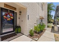 Charming front entrance featuring a decorative door wreath and well-maintained landscaping at 4214 Harbor House Dr, Tampa, FL 33615