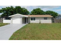 Charming single-story home with a well-maintained lawn and a freshly painted driveway at 4417 Kohler St, New Port Richey, FL 34652