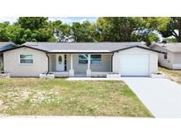 Charming single-story home featuring a well-manicured lawn and an attached one car garage at 4638 Durney St, New Port Richey, FL 34652