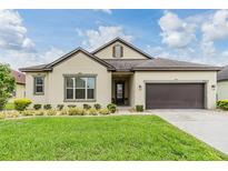 Charming one-story home with a well-manicured lawn and a two car garage at 4716 Butler National Dr, Wesley Chapel, FL 33543