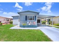Charming single-story home with a covered carport and well-manicured lawn at 4904 Winged Foot Ave, Sarasota, FL 34234