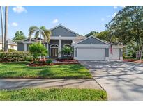 Charming two-story home with a three car garage and well manicured landscaping at 4959 Felecity Way, Palm Harbor, FL 34685