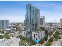 Modern high-rise condo with glass windows, pool, and city views on a bright and sunny day at 777 N Ashley Dr # 2510, Tampa, FL 33602