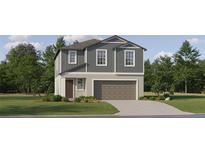 Charming two-story home with neutral siding, inviting entrance, and attached two car garage at 9437 Raised Tulip Ln, Land O Lakes, FL 34637