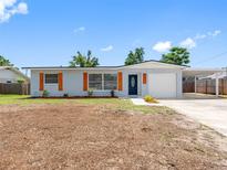 Charming single-story home featuring a carport, front lawn, and modern exterior paint at 1213 W Camellia Dr, Brandon, FL 33510