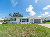 Charming single-story home featuring a well-maintained lawn and a bright white exterior at 14045 90Th Pl, Seminole, FL 33776