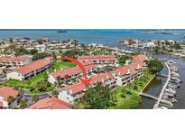 Breathtaking aerial view of a waterfront community, lush landscaping, and boat docks, offering a serene coastal lifestyle at 2363 Hanover Dr, Dunedin, FL 34698