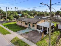 Charming single-story home featuring a screened porch, solar panels, and a well-maintained front lawn at 2501 18Th S Ave, St Petersburg, FL 33712