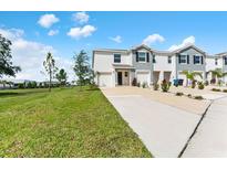 New construction townhome featuring a two-car garage, and neutral colored exteriors at 308 Mangrove Shade Cir, Apollo Beach, FL 33572