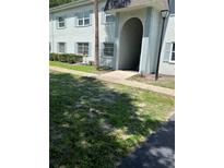 Two-story building with light blue exterior paint, blue shutters, and well-maintained landscaping in a sunny, inviting neighborhood at 337 S Mcmullen Booth Rd # 157, Clearwater, FL 33759