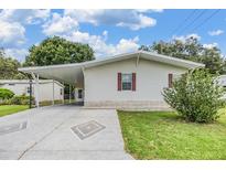 Charming single-story home featuring carport, manicured lawn, and lovely landscaping at 36731 Tara Ave, Zephyrhills, FL 33542