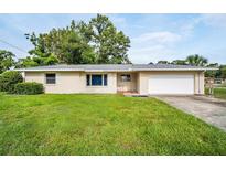 Charming single-story home with a well-maintained lawn and a classic suburban design at 410 N Corona Ave, Clearwater, FL 33765