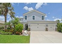 Beautiful two-story home featuring a three car garage and a well-manicured lawn at 4151 Little Gap Loop, Ellenton, FL 34222