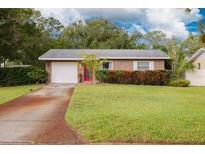 Charming single-story home with well-maintained lawn, brick facade, and driveway at 5700 Pacific N St, St Petersburg, FL 33703