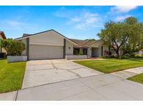Charming single-Gathering home with an attached two-car garage and a well-manicured front yard at 14164 Fennsbury Dr, Tampa, FL 33624