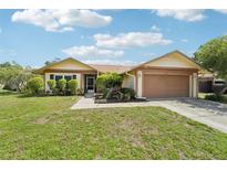 Charming single-story home with well-maintained landscaping and a two-car garage at 2714 Witley Ave, Palm Harbor, FL 34685