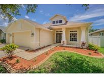 Charming home with a well-manicured lawn, neat mulch beds, and a welcoming covered entryway at 2957 Hickory Grove Dr, Valrico, FL 33596