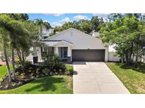 Charming single-story home with a two-car garage, well-manicured lawn, and beautiful landscaping at 710 W Peninsular St, Tampa, FL 33603