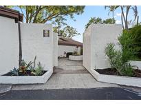 Welcoming entrance featuring lush landscaping and clear signage for the units at 1881 N Hercules Ave # 1501, Clearwater, FL 33765