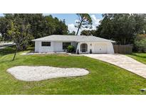 Charming single-story home with a well-maintained lawn, driveway, and a one-car garage at 21426 Quesada Ave, Port Charlotte, FL 33952