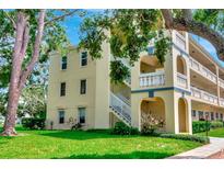 Inviting exterior view of a multi-story building with lush landscaping and a charming architectural design at 2253 Norwegian Dr # 27, Clearwater, FL 33763