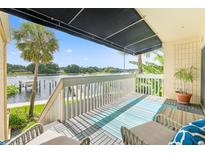 Balcony with covered awning overlooking waterfront views and a railing at 2424 W Tampa Bay Blvd # G204, Tampa, FL 33607