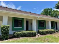 Inviting single story villa with green framed windows and manicured shrubs at 2541 Laurelwood Dr # 8C, Clearwater, FL 33763