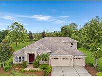 Stunning single-story home with a manicured front yard and a three-car garage at 7244 Wild Oak Ln, Land O Lakes, FL 34637