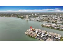 Stunning aerial view of waterfront condos with bay views and surrounding landscape at 7665 Sun Island Dr # 206, South Pasadena, FL 33707