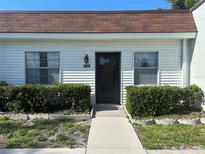 Inviting home exterior featuring a well-maintained front yard and charming facade at 13829 Mission Oaks Blvd, Seminole, FL 33776