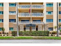 Low angle of the building's facade featuring stone accents, balconies, and the Shore Crest sign at 1200 N Shore Ne Dr # 404, St Petersburg, FL 33701