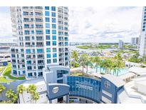Close aerial view of white high-rise towers with private balconies and a beautiful pool area at 1209 E Cumberland Ave # 1003, Tampa, FL 33602