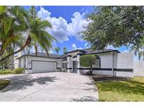 Charming single-story home featuring a two-car garage, manicured landscaping, and a welcoming front entrance at 1218 Willow Bend Way, Lutz, FL 33549