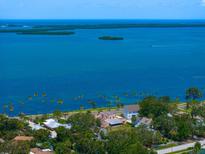 Expansive aerial view showcases waterfront property with lush landscaping and bay views at 43 Edgewater Dr, Dunedin, FL 34698