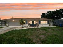 Charming single-story home with a well-manicured lawn and a welcoming front entrance at sunset at 6236 17Th S St, St Petersburg, FL 33712