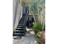 Exterior view of property entrance with tropical landscaping at 7821 Niagara Ave # 2102, Tampa, FL 33617