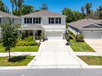 Beautiful two-story home with a well-manicured lawn and a two-car garage at 8423 Praise Dr, Tampa, FL 33625