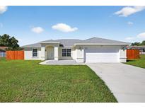Charming single-story home with a well-manicured lawn and inviting front entrance at 10115 Briar Cir, Hudson, FL 34667