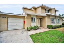 Charming townhouse with a well-maintained lawn, inviting entry and a one car garage at 1660 Cape Ann Ne Ave # 2, St Petersburg, FL 33702
