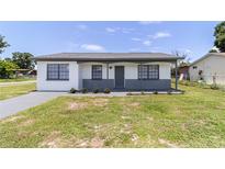 Charming single-story home featuring a freshly painted exterior and well-maintained front lawn at 2425 Wishing Well Cir, Tampa, FL 33619